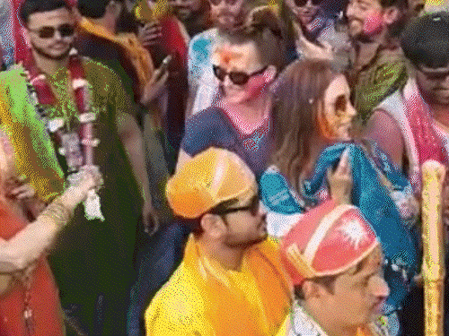 Gopis in Gokul showered policemen with sticks. VIDEO: Even foreigners were not spared; they dressed up like brides and played stick-wielding Holi.